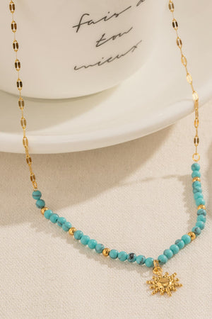 Gold celestial sunburst beaded necklace with turquoise and gold beads