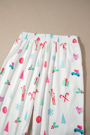 White pajama pants with festive Christmas print including nutcrackers, candy canes, trees, and gifts.