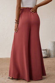 Crimson palazzo trousers with paperbag waist and wide leg, styled with a white crop top.