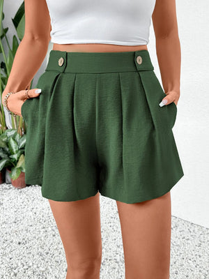 Dark green high-waisted pleated shorts with button detail and pockets