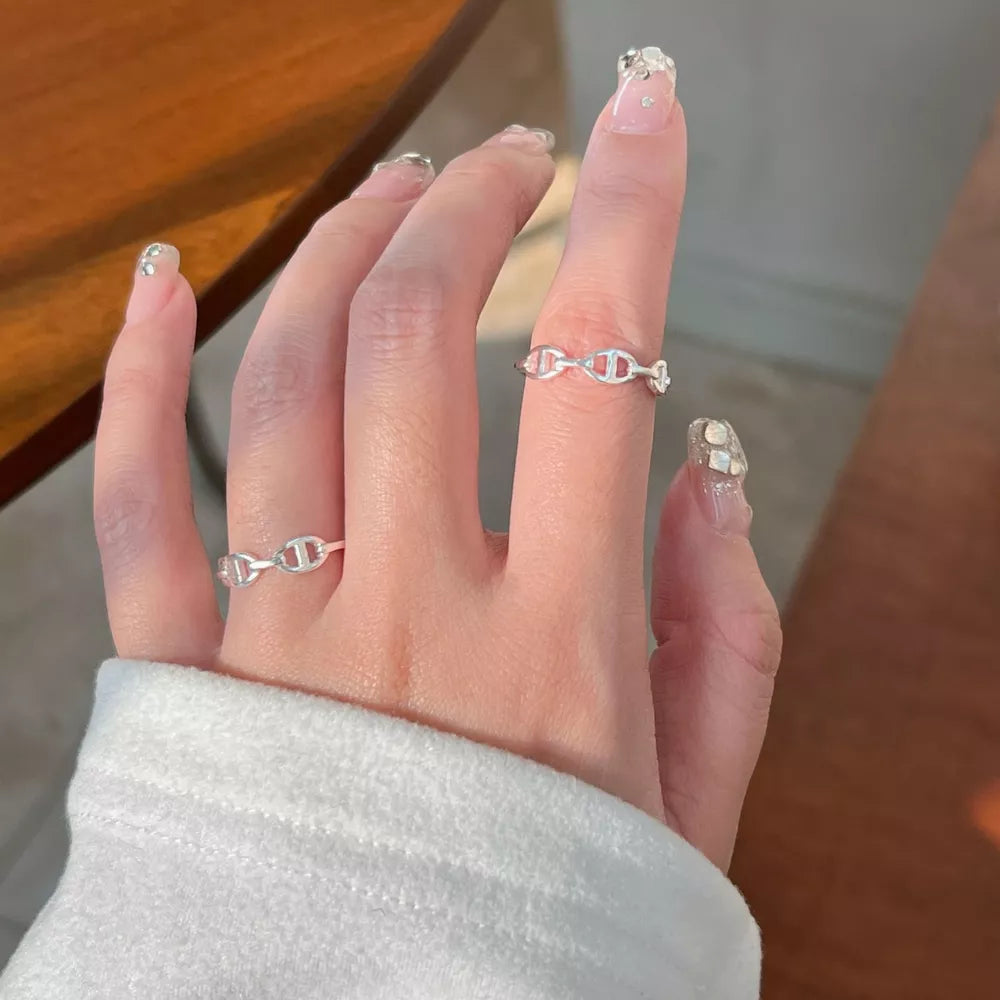 Sleek sterling silver ring with a chain-link geometric design.