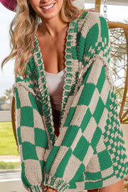 Green and beige checkered acrylic cardigan with balloon sleeves and open front.