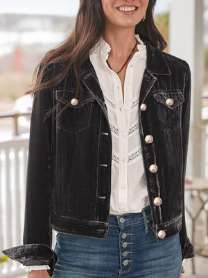 Black velvet western jacket with silver buttons and chest pockets.