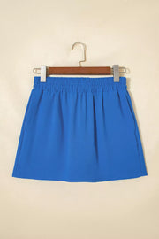 Blue drawstring shorts with elastic waistband and side pockets.