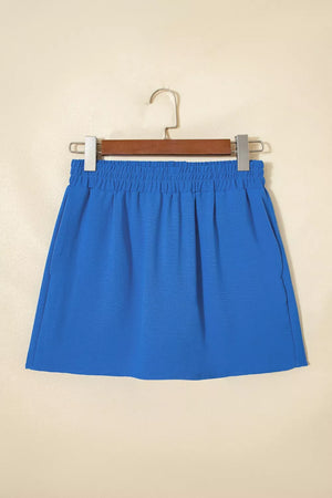 Blue drawstring shorts with elastic waistband and side pockets.