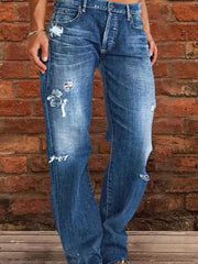 Blue denim maternity jeans with relaxed fit, distressed details, and raw hem