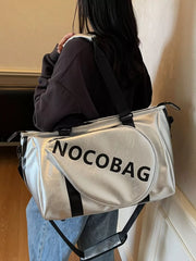 Silver leather duffel bag with black straps and "NOCOBAG" text detail.