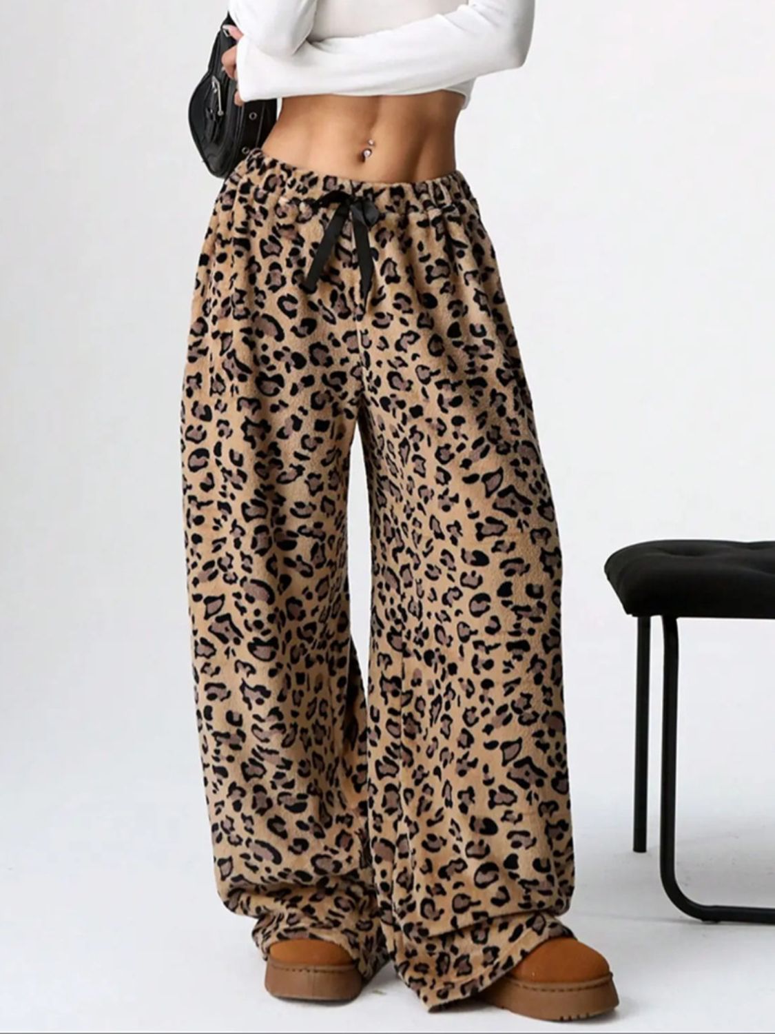 Leopard print lounge palazzo trousers with a black bow detail and wide leg.