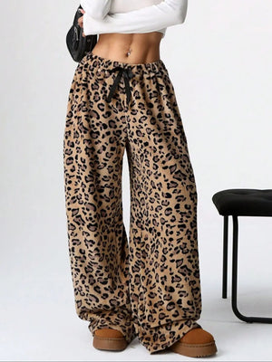 Leopard print lounge palazzo trousers with a black bow detail and wide leg.