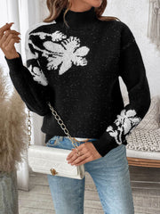Black acrylic mock neck sweater with white floral embellishments and subtle sparkle details.
