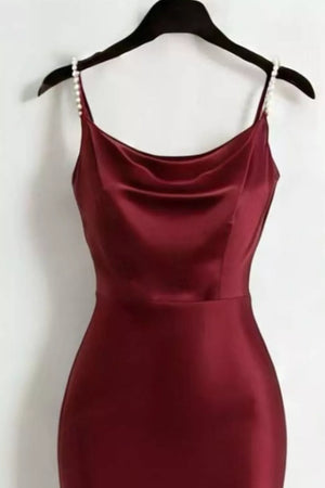 Burgundy satin cowl neck maxi dress with pearl-embellished straps.