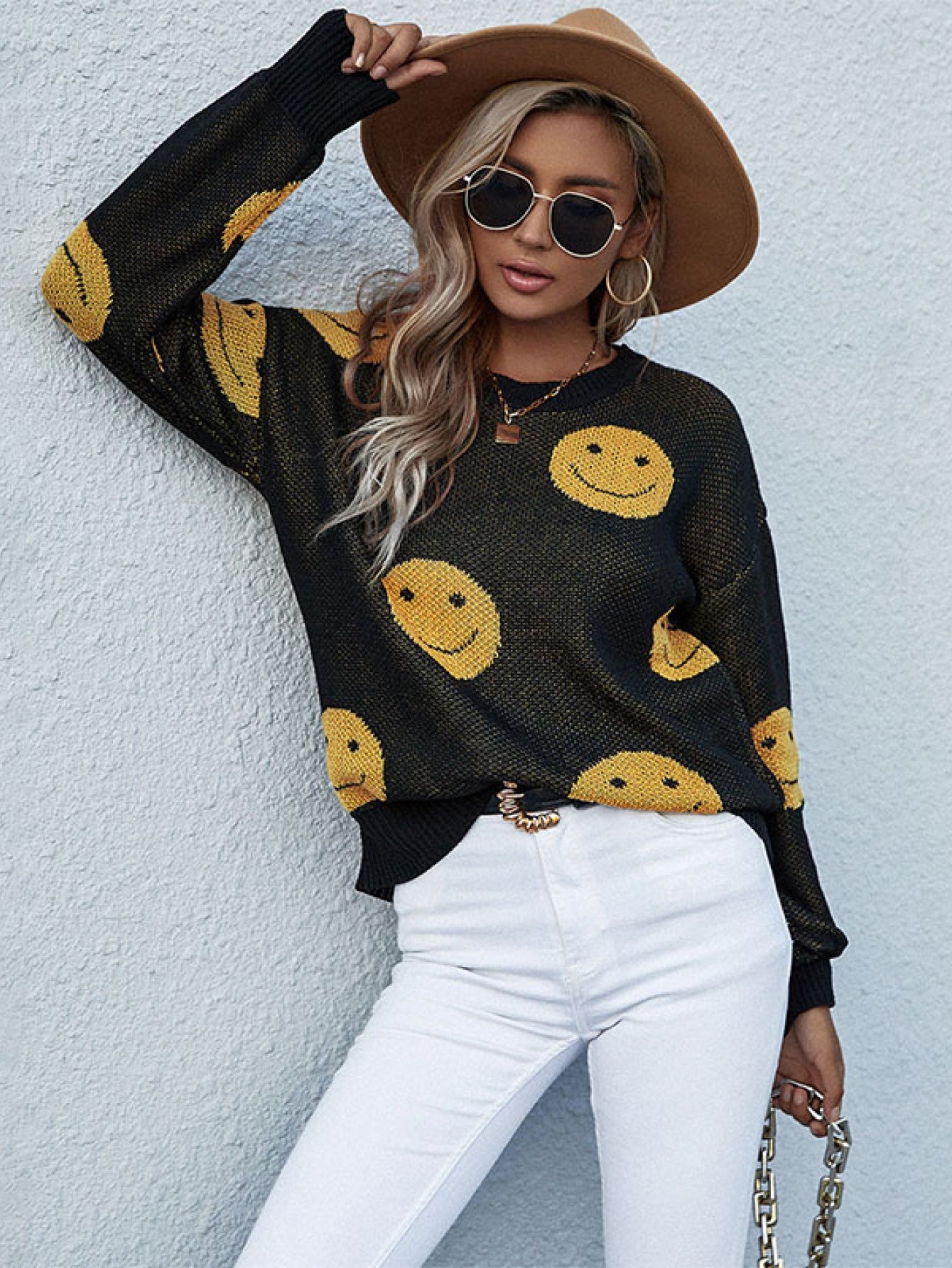 Black smiley face jacquard knit sweater with crew neck and long sleeves.