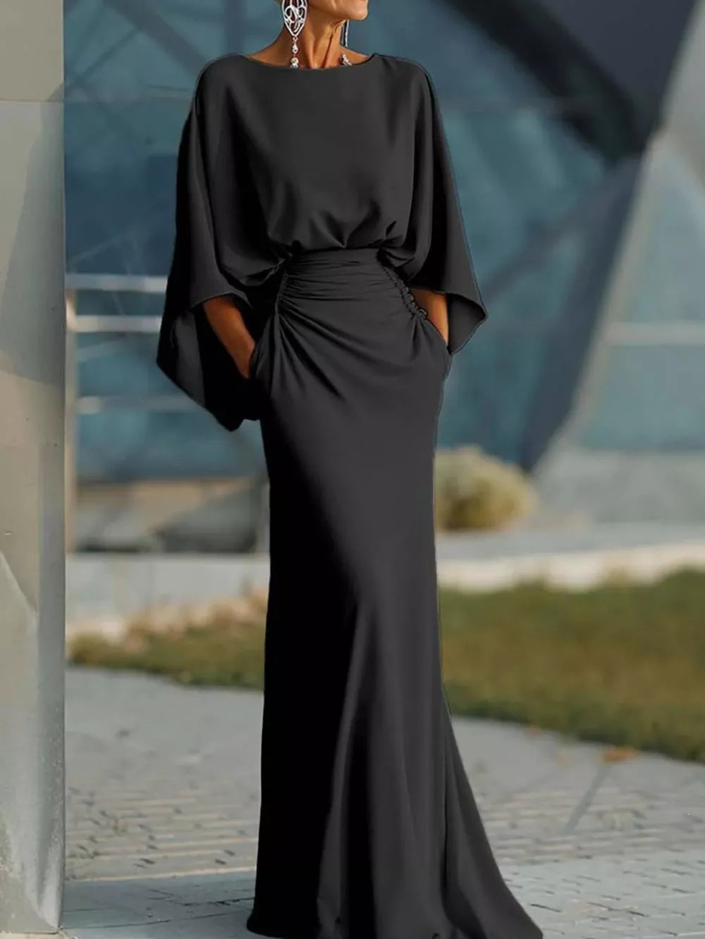 Black batwing sleeve maxi dress with ruched waist detail and pockets.