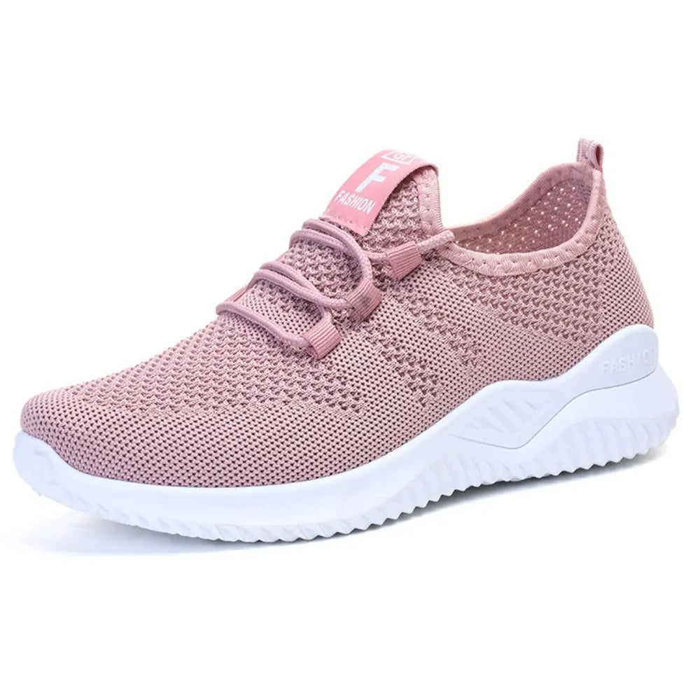Pink breathable knit runner sneaker with white sole and logo detail.