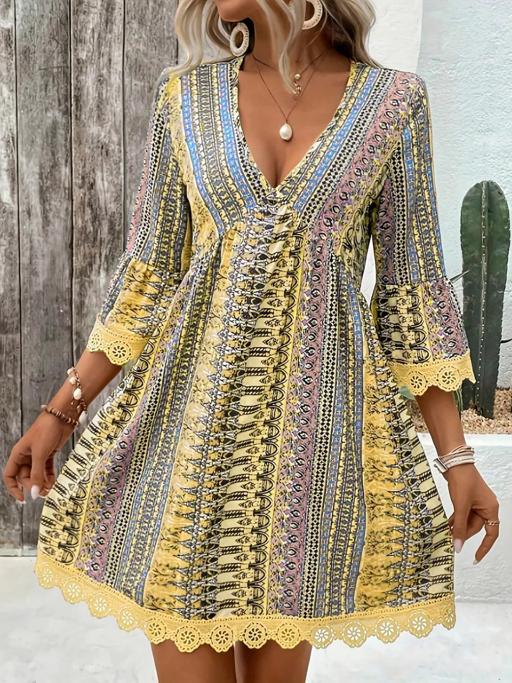 Bohemian yellow printed v-neck dress with bell sleeves and lace trim