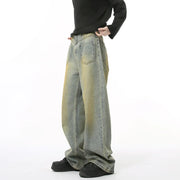 Distressed medium wash wide leg jeans with yellow acid wash details.