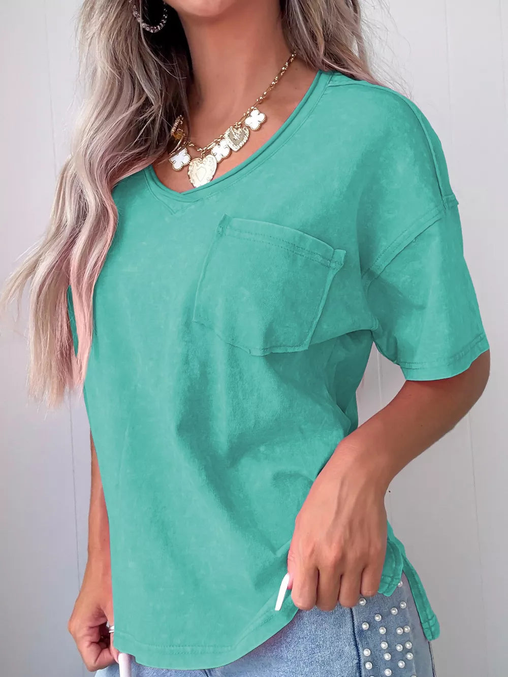Mineral wash cotton tee in teal with a chest pocket and V-neck.