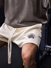Ivory fleece drawstring shorts with a market logo detail and a relaxed fit.
