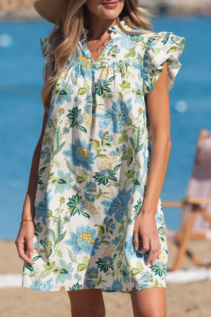 Floral v-neck mini dress with ruffled sleeves in cotton, featuring blue and green floral print.
