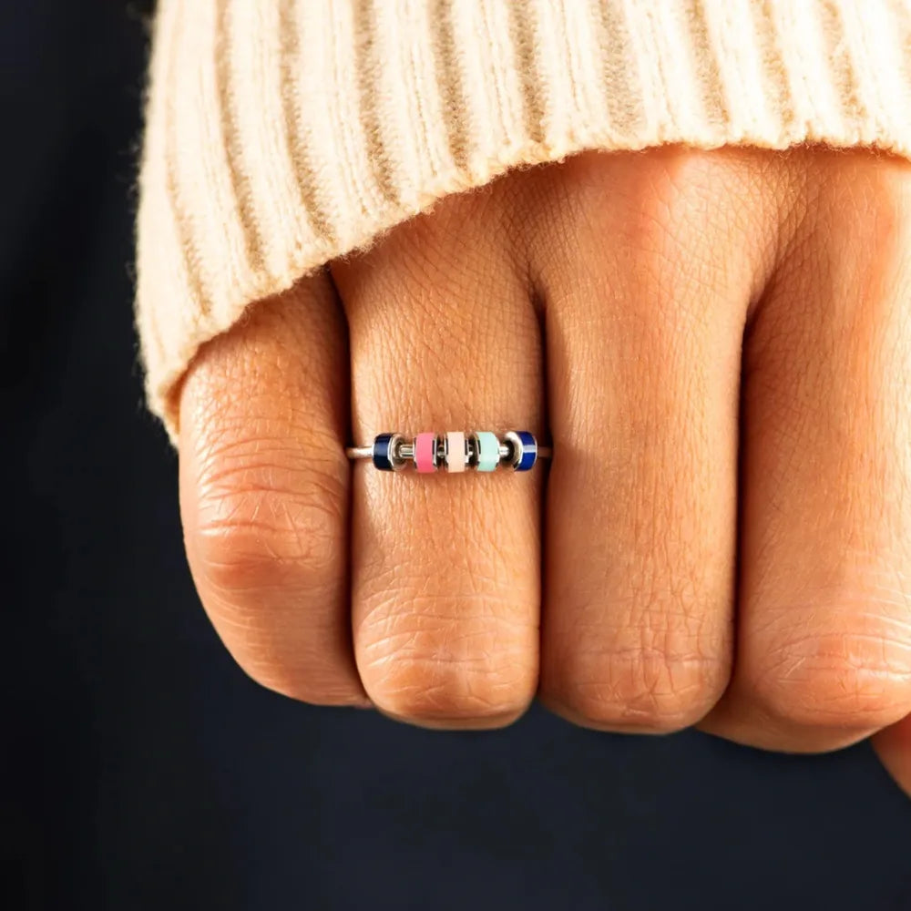 Sterling ring with colorful beads in pink, light blue, and navy.