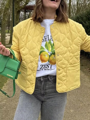 Yellow quilted snap puffer jacket with a crew neck and snap button closure.