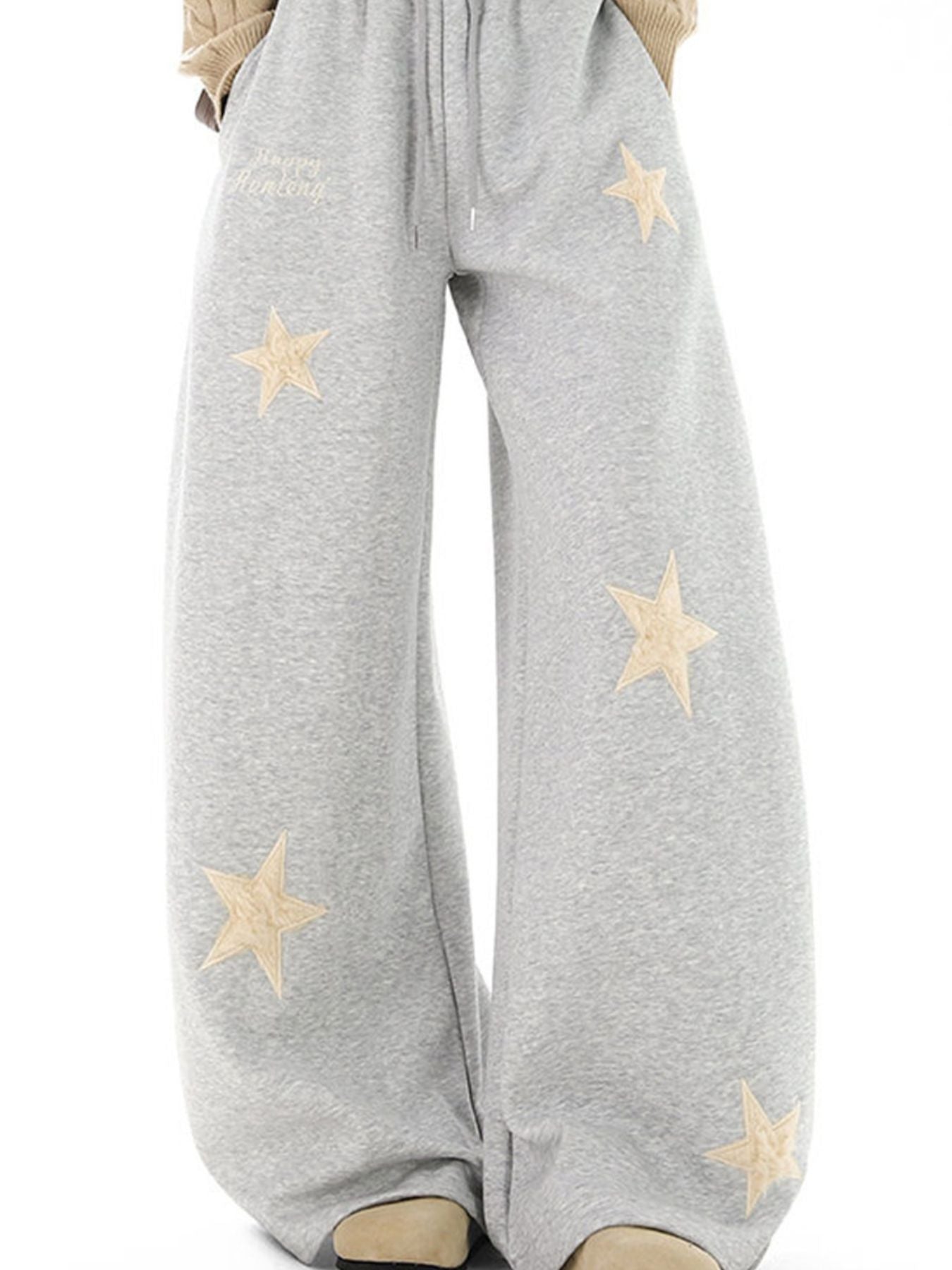 Gray wide leg sweatpants with drawstring and embroidered stars.