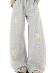 Gray wide leg sweatpants with drawstring and embroidered stars.