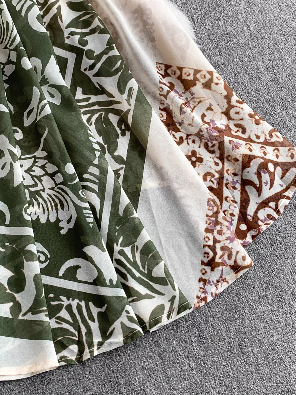 Dual-pattern V-neck cami dress with green leaf print and brown paisley detail.