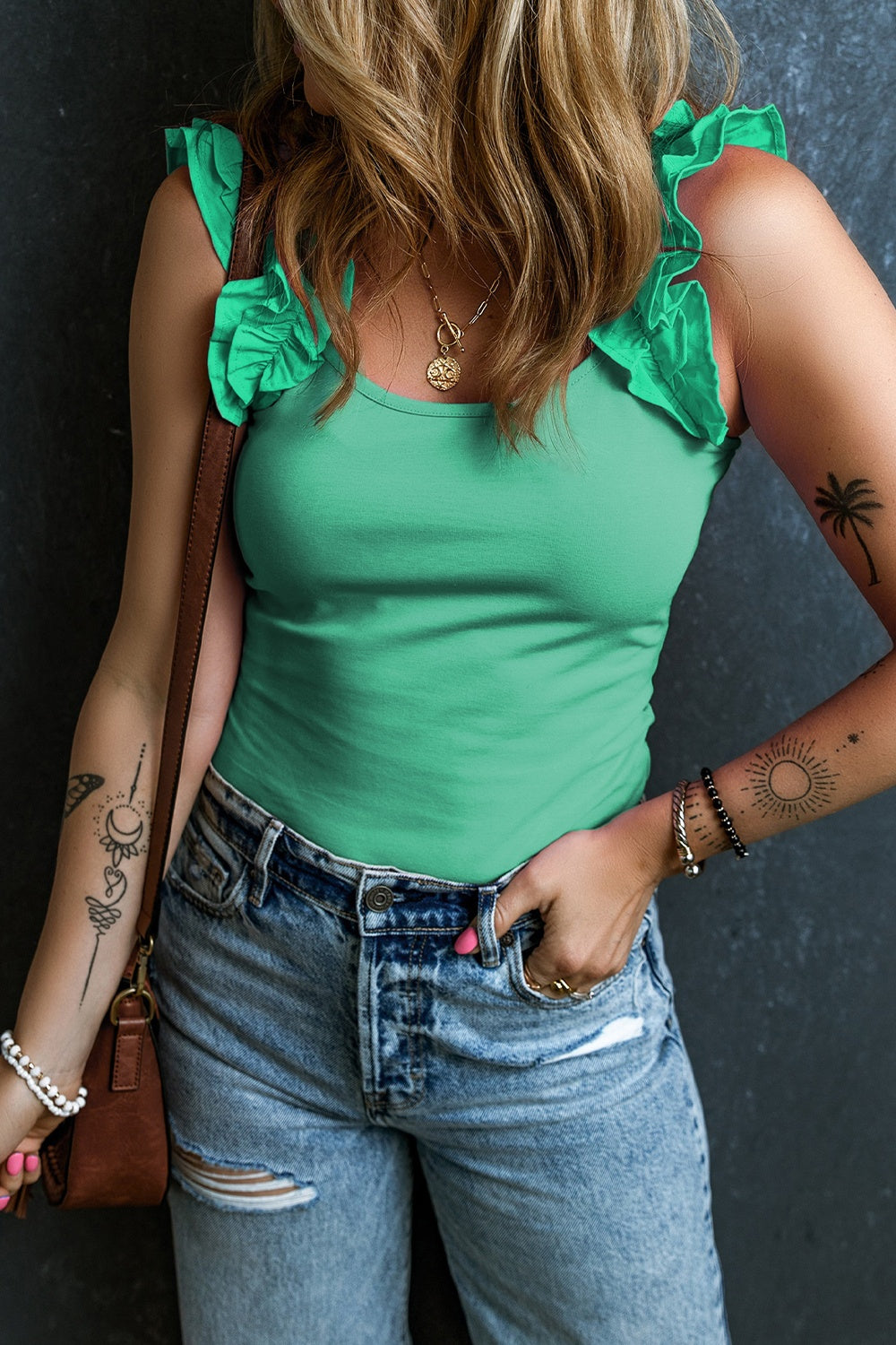 Light green ribbed tank top with ruffled straps and a scoop neckline.