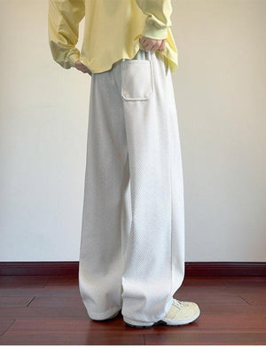 Men's white textured wide leg sweatpants with a single patch pocket.