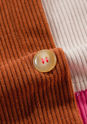 Colorblock corduroy shacket with patchwork detail and a tan button.