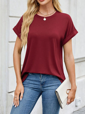 Burgundy t-shirt with cuffed sleeves and crew neck, styled with jeans and a clutch.