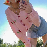 Pink cropped cardigan with cherry embroidery and red buttons