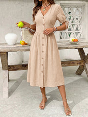 Tan button-down midi dress with tie sleeve details and V-neckline.