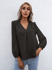 Black Swiss dot sleeve gathered blouse with V-neck and cinched cuffs.