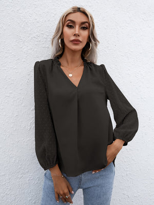Black Swiss dot sleeve gathered blouse with V-neck and cinched cuffs.