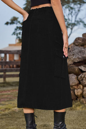 Black denim midi skirt with cargo pockets and a slit, styled with boots.