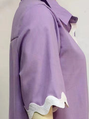 Lilac linen pajama top with scalloped trim on the sleeves and neckline.