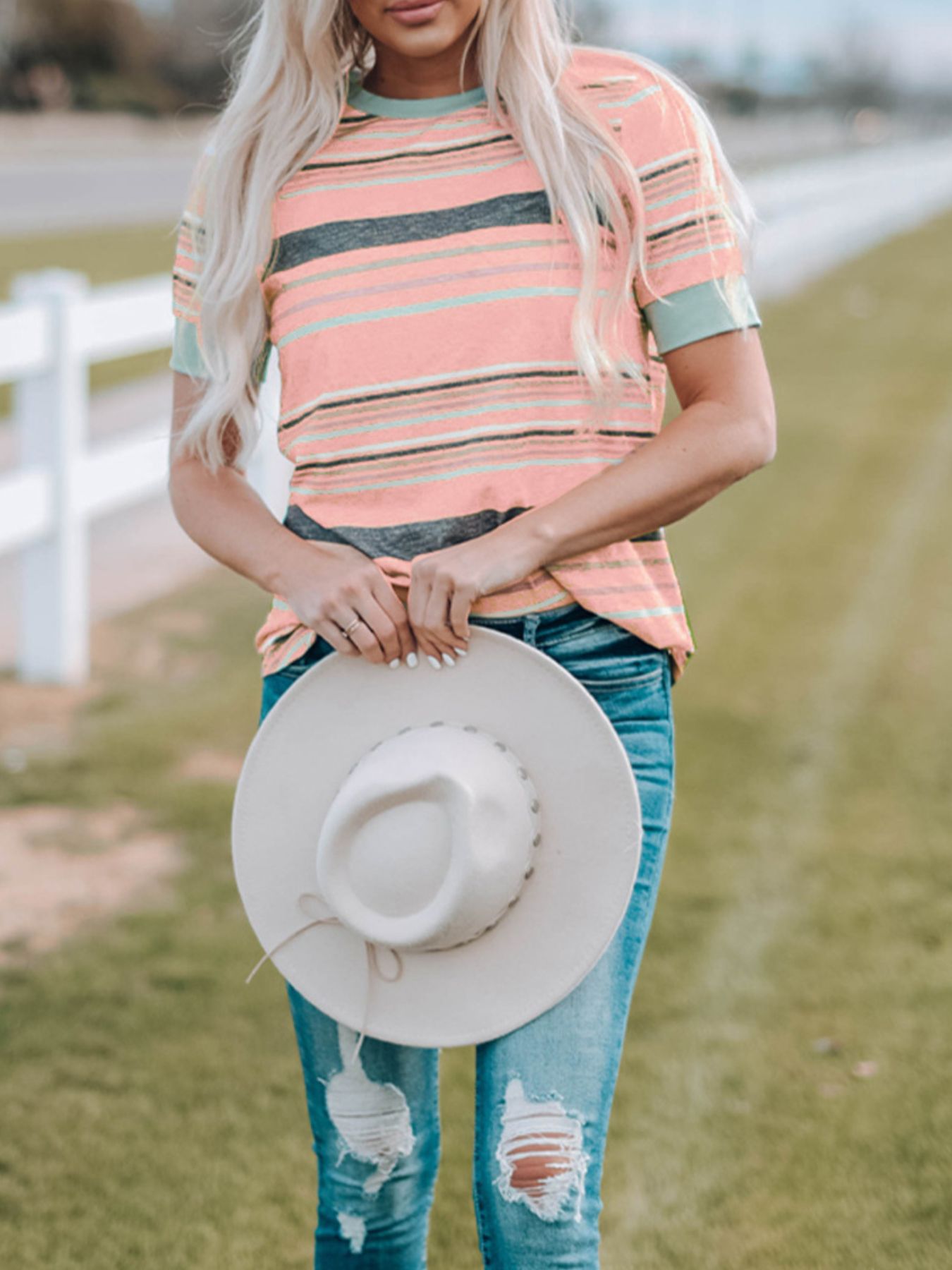 Striped crew neck t-shirt in dusty pink with grey and mint green stripes, short sleeves.