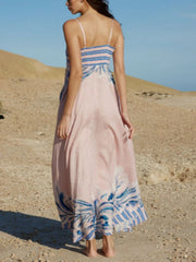 Pink spaghetti strap maxi dress with blue abstract print and bustier detail.