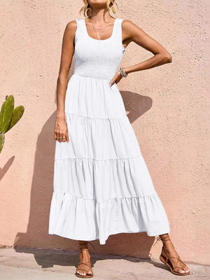 White smocked bodice tiered maxi dress with square neckline and sleeveless design.