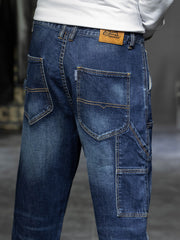 Dark blue 100% cotton cargo jeans with relaxed fit and multiple pockets.