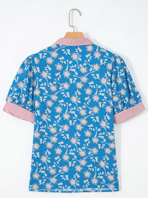 Blue cotton blouse with floral print, puff sleeves, and red and white striped collar and cuffs.