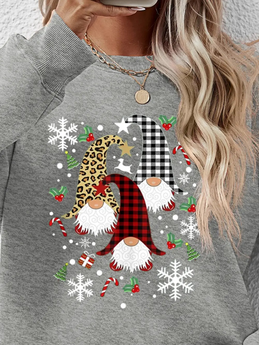 Grey raglan sweatshirt with festive gnome graphic, snowflakes, candy canes, and Christmas trees.
