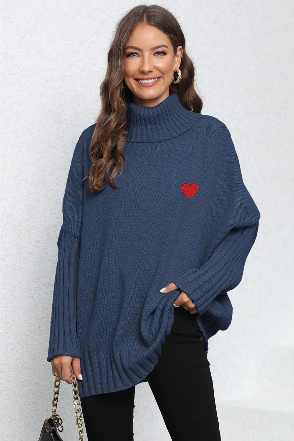 Dark Blue batwing knit turtleneck sweater with red heart embroidery and ribbed sleeves.