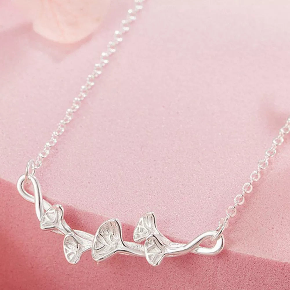 Silver necklace with a delicate ginkgo leaf design and chain.