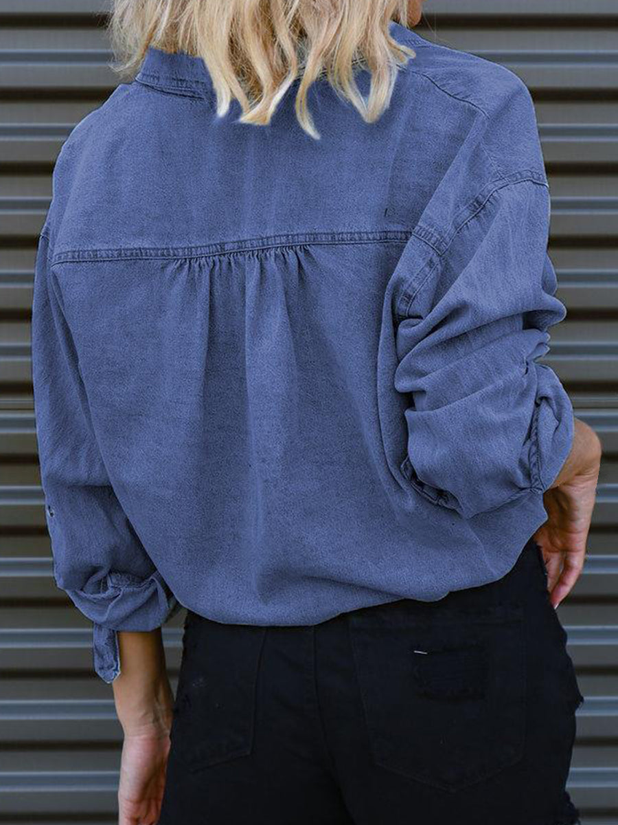 Cropped denim blouson shirt in medium blue with buttoned cuffs and gathered back detail.