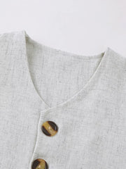 Baby vest set in light grey linen-look fabric with tortoiseshell buttons.