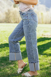 Maternity relaxed fit jeans in light wash denim with distressed details and wide striped cuffs.