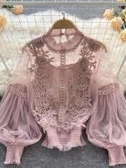 Light pink lace blouse with floral embroidery, sheer puff sleeves, and ruffled hem.